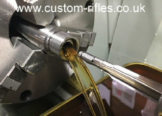 Cutting the chamber with a Manson reamer using high pressure through barrel lubrication.